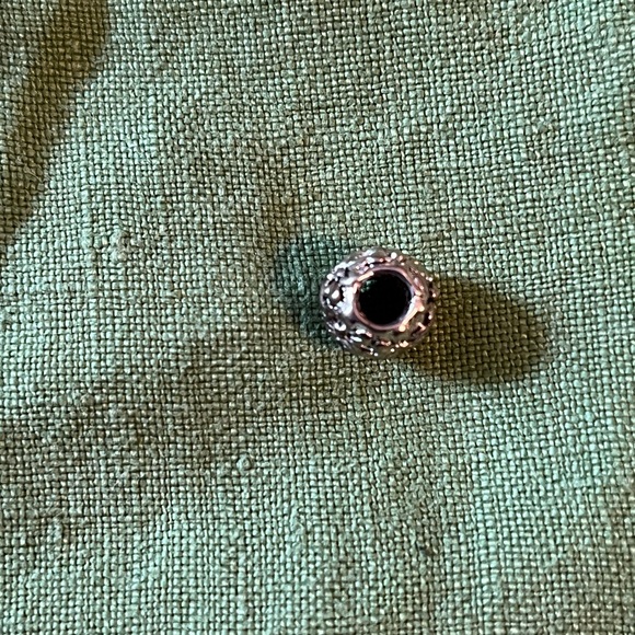 Pandora silver charm with flower design, approximately 1/3rd of an inch around. - Picture 3 of 5